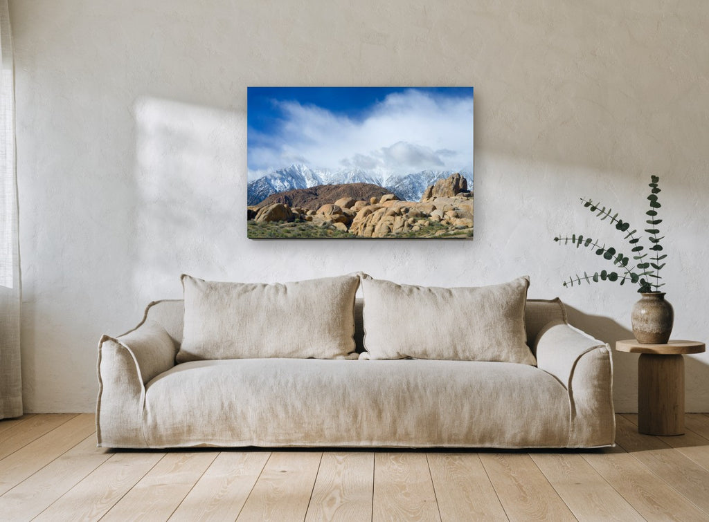 Boulders Beneath Snow Peaks landscape canvas print on the wall of a living room