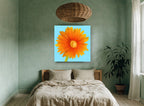 Orange Gerbera Sky floral canvas print on the wall of a bedroom
