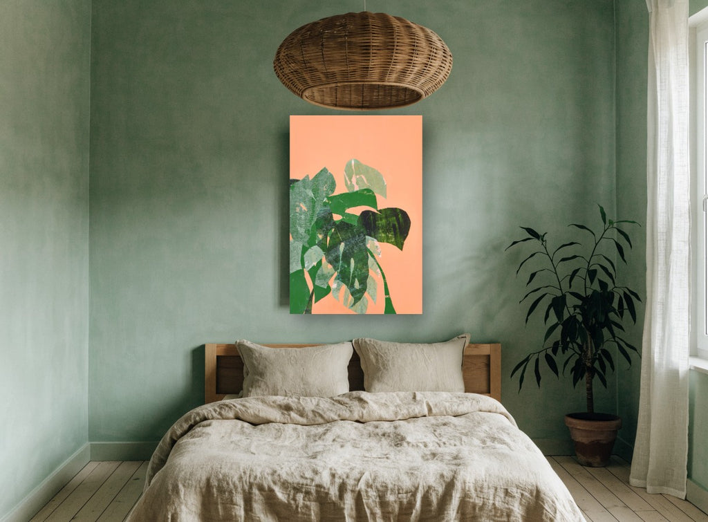 Monstera Collage on Peach floral canvas print on the wall of a bedroom
