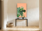 Monstera Collage on Peach floral canvas print on the wall of a hallway
