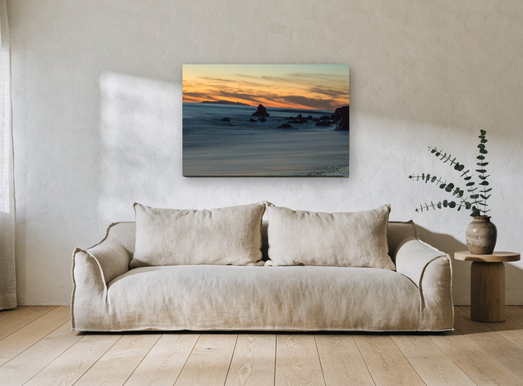 Dusk Rocks Silk Tide coastal canvas print on the wall of a living room