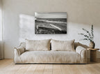 Driftwood Shore Light coastal canvas print on the wall of a living room