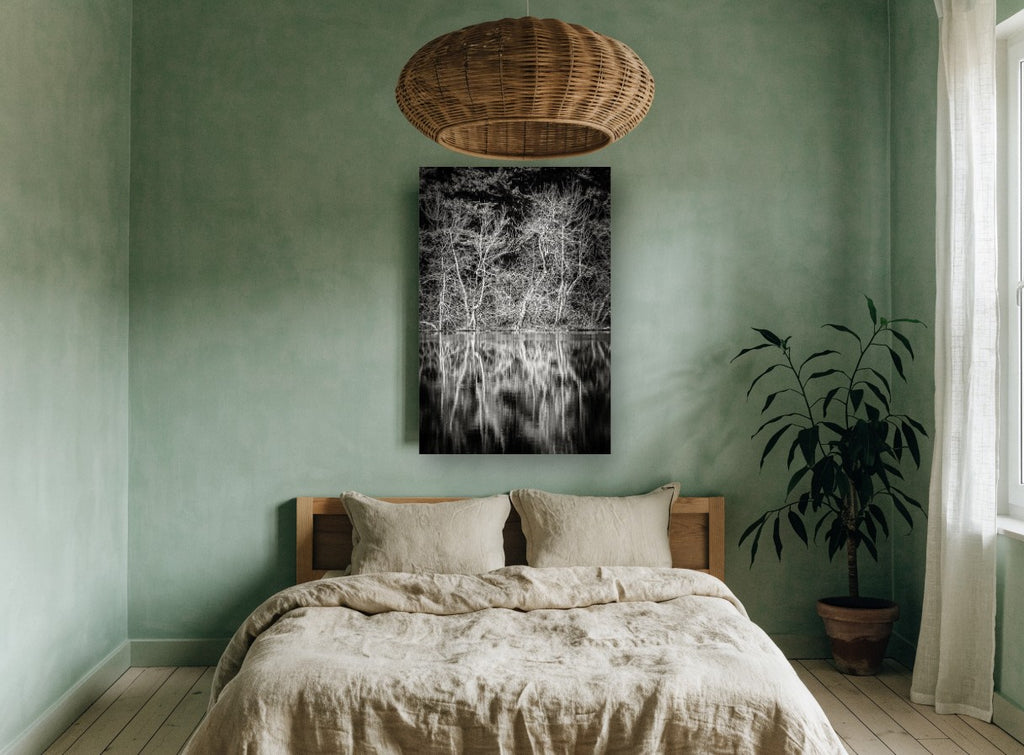 Bare Branches Mirrored landscape canvas print on the wall of a bedroom