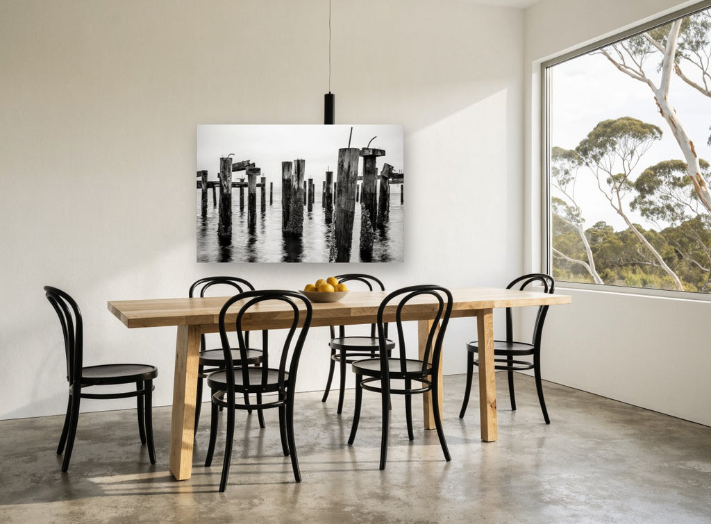 Barnacled Pier Posts coastal canvas print on the wall of a dining room