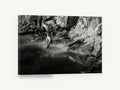 Driftwood and Still Water, black and white rocky shoreline photograph, landscape canvas wall art print ready to hang