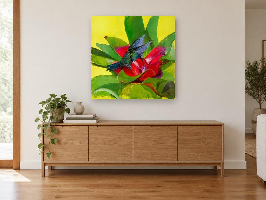 Hummingbird at Red Bromeliad floral canvas print on the wall of a living room above a sideboard