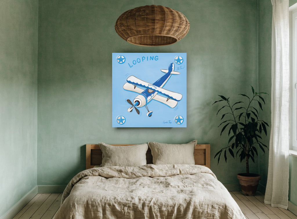 Blue Looping Biplane kids canvas print on the wall of a bedroom