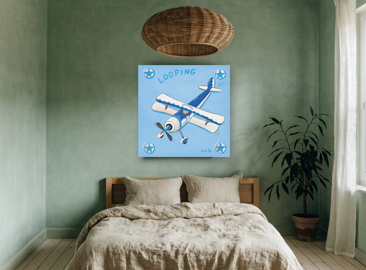 Blue Looping Biplane kids canvas print on the wall of a bedroom