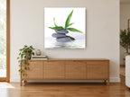 Stacked Stones Bamboo Calm floral canvas print on the wall of a living room above a sideboard
