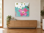 Pink Dogwood on Teal floral canvas print on the wall of a living room above a sideboard
