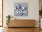 Petals on Heart Stones floral canvas print on the wall of a living room above a sideboard