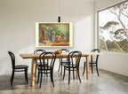 Native Blooms and Old Tins floral canvas print on the wall of a dining room