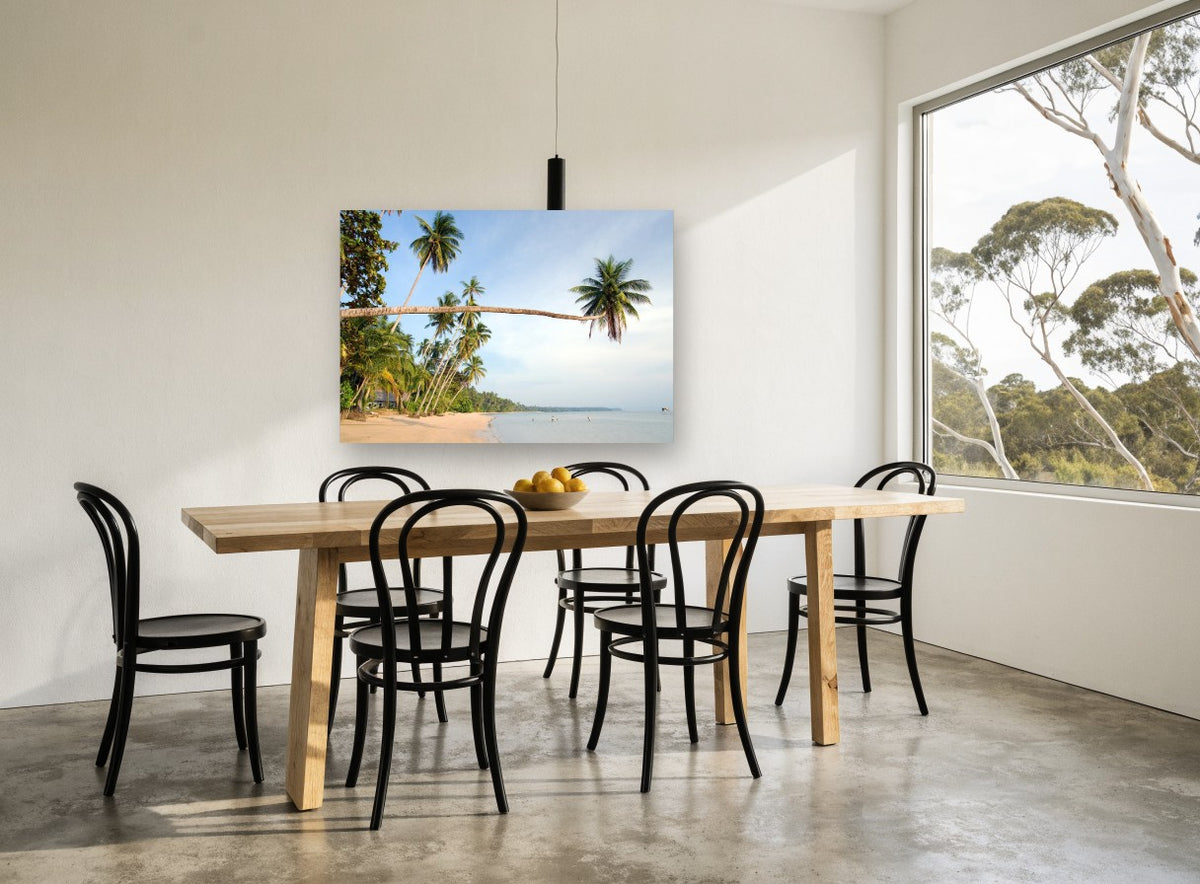 Leaning Palm Bay coastal canvas print on the wall of a dining room