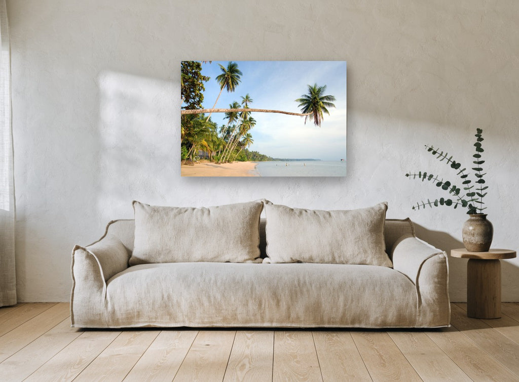 Leaning Palm Bay coastal canvas print on the wall of a living room