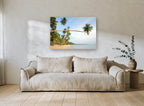 Leaning Palm Bay coastal canvas print on the wall of a living room