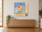 Pink Conch Collage coastal canvas print on the wall of a living room above a sideboard