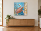 Sea Turtle Driftwood Panel coastal canvas print on the wall of a living room above a sideboard
