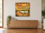 Take to the Road vintage canvas print on the wall of a living room above a sideboard