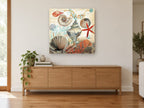 Seashore Shell Collage coastal canvas print on the wall of a living room above a sideboard