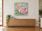 Peonies in the Garden floral canvas print on the wall of a living room above a sideboard