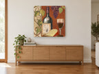 Le Vin de Renommée vintage canvas print on the wall of a living room above a sideboard