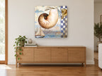 Nautilus Shell Collage coastal canvas print on the wall of a living room above a sideboard