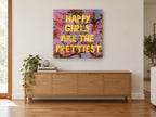 Happy Girls Blossom Typography floral canvas print on the wall of a living room above a sideboard