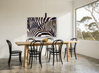 Zebra Stripe Huddle animal canvas print on the wall of a dining room
