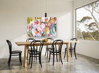 Orchid Garden Glow floral canvas print on the wall of a dining room