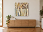 Birch Grove Haze landscape canvas print on the wall of a living room above a sideboard