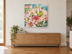 Pink Lily Cluster floral canvas print on the wall of a living room above a sideboard