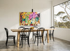 Cherries and Pink Blooms floral canvas print on the wall of a dining room