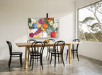 Daisies and Citrus Table floral canvas print on the wall of a dining room