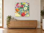 Daisies and Orange Table floral canvas print on the wall of a living room above a sideboard