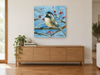 Chickadee on Snowy Branch animal canvas print on the wall of a living room above a sideboard