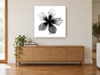 Hibiscus Star Silhouette floral canvas print on the wall of a living room above a sideboard