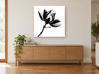 Magnolia in Silhouette floral canvas print on the wall of a living room above a sideboard