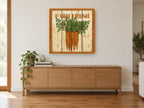 Farm Fresh Carrots vintage canvas print on the wall of a living room above a sideboard