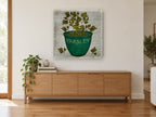 Green Pot Parsley vintage canvas print on the wall of a living room above a sideboard