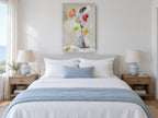 Loose Bouquet in Grey floral canvas print on the wall of a coastal bedroom