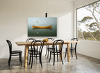 Canoe and Gull Calm coastal canvas print on the wall of a dining room