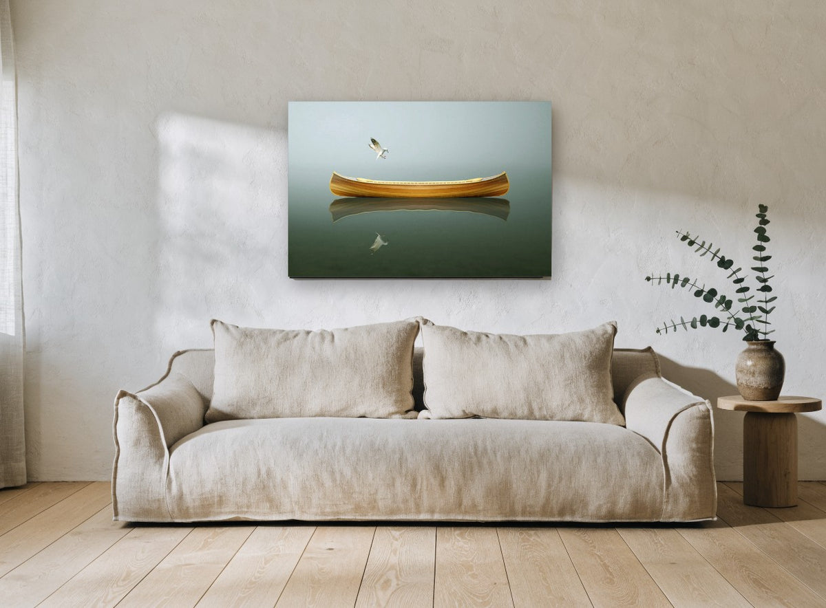 Canoe and Gull Calm coastal canvas print on the wall of a living room
