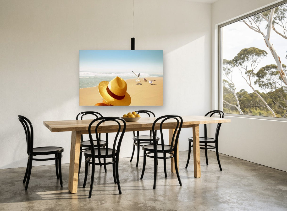 Hat and Seagulls coastal canvas print on the wall of a dining room