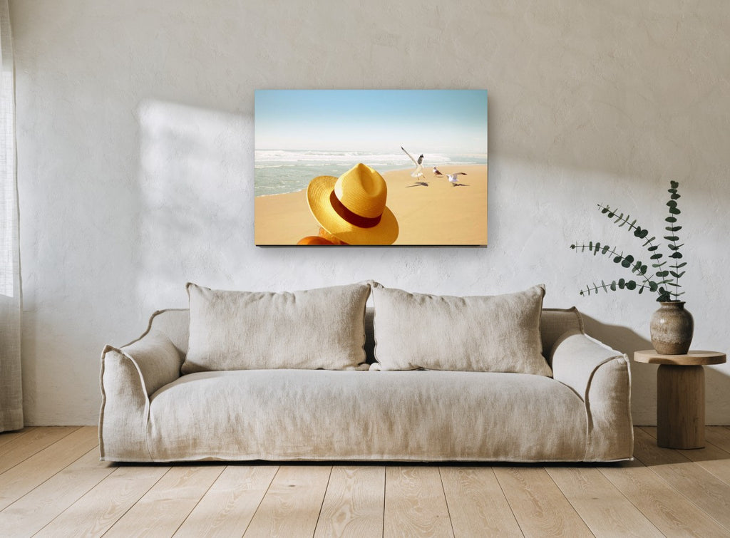 Hat and Seagulls coastal canvas print on the wall of a living room