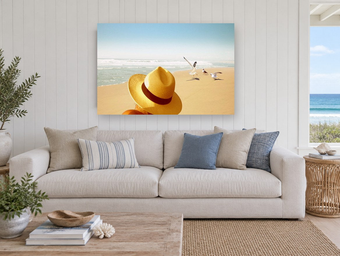Hat and Seagulls coastal canvas print on the wall of a beach house living room