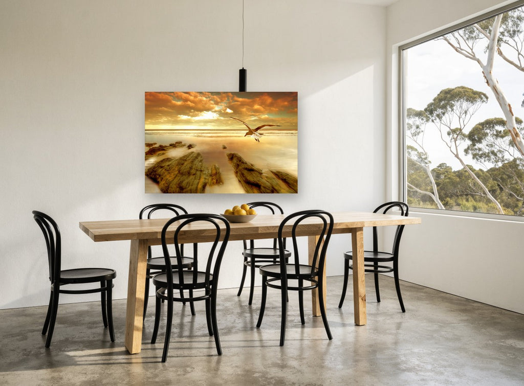 Gull Over Golden Shore coastal canvas print on the wall of a dining room