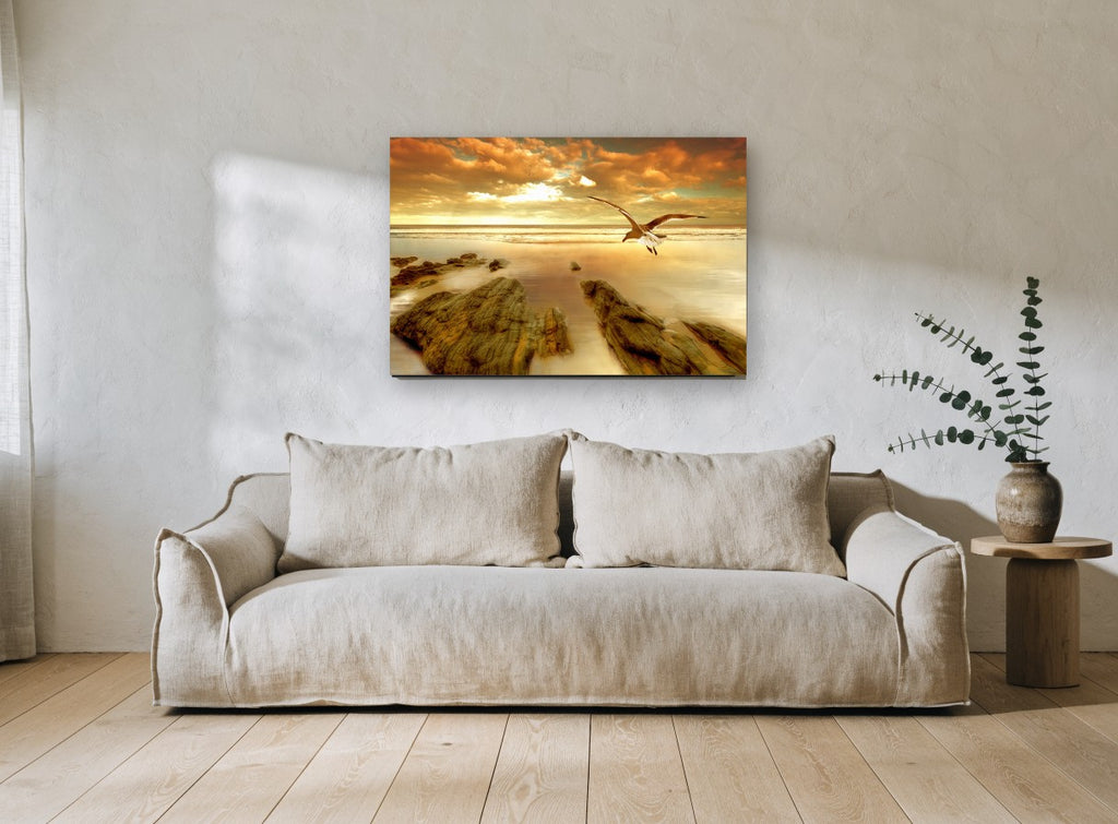 Gull Over Golden Shore coastal canvas print on the wall of a living room