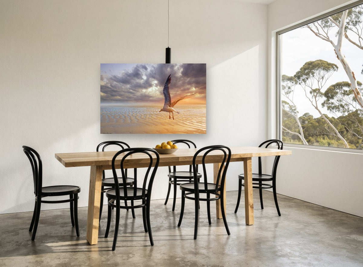 Gull Over Rippled Sands coastal canvas print on the wall of a dining room