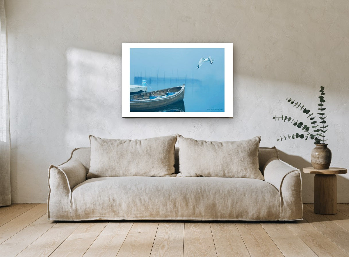 Gull Over Foggy Bay coastal canvas print on the wall of a living room