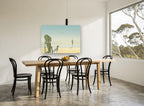 Chair and Seagulls coastal canvas print on the wall of a dining room